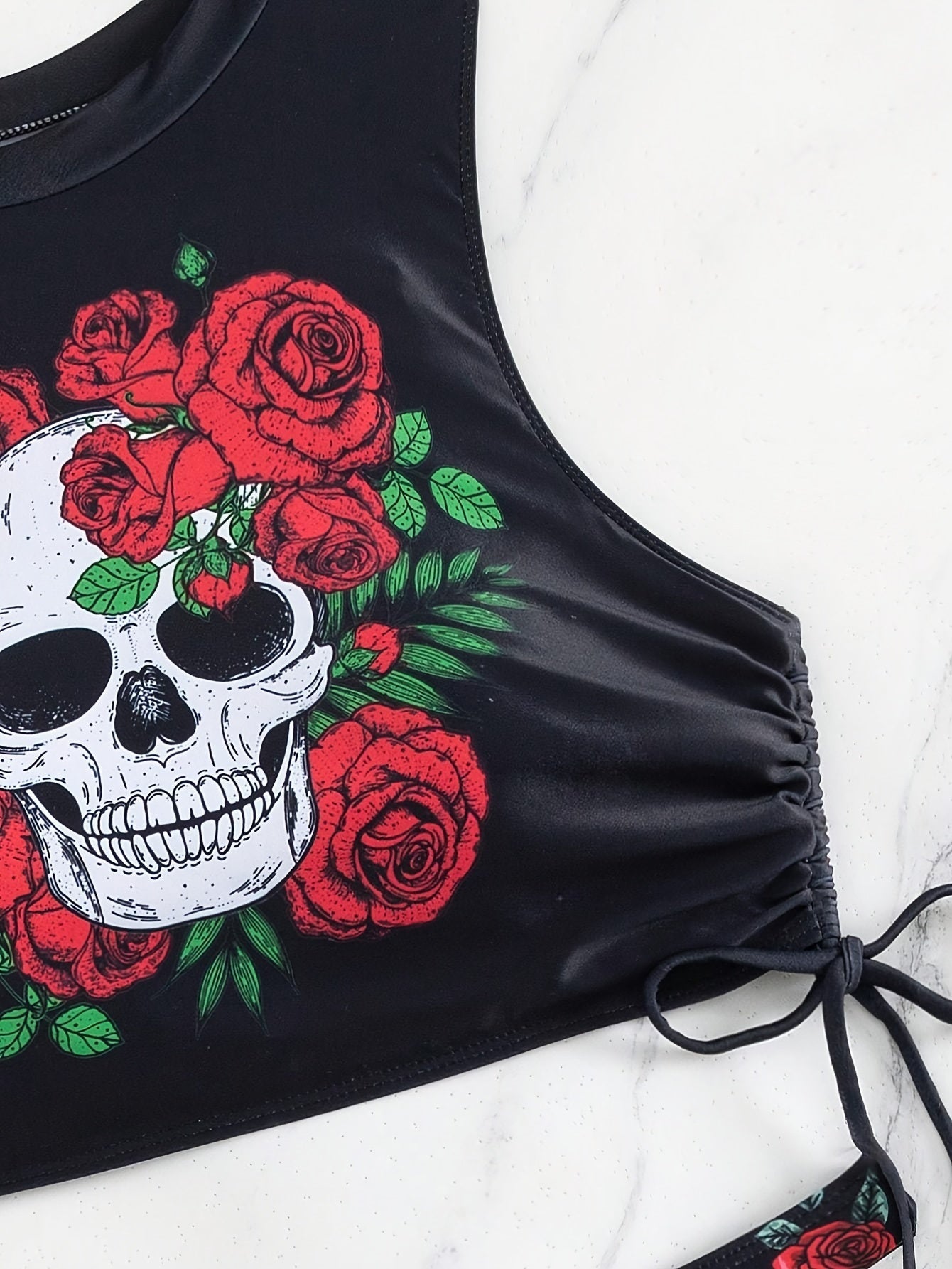 Stevvex bikini set featuring skull print, floral tie, lace-up design, and hollow-out details for beach and summer festivals.
