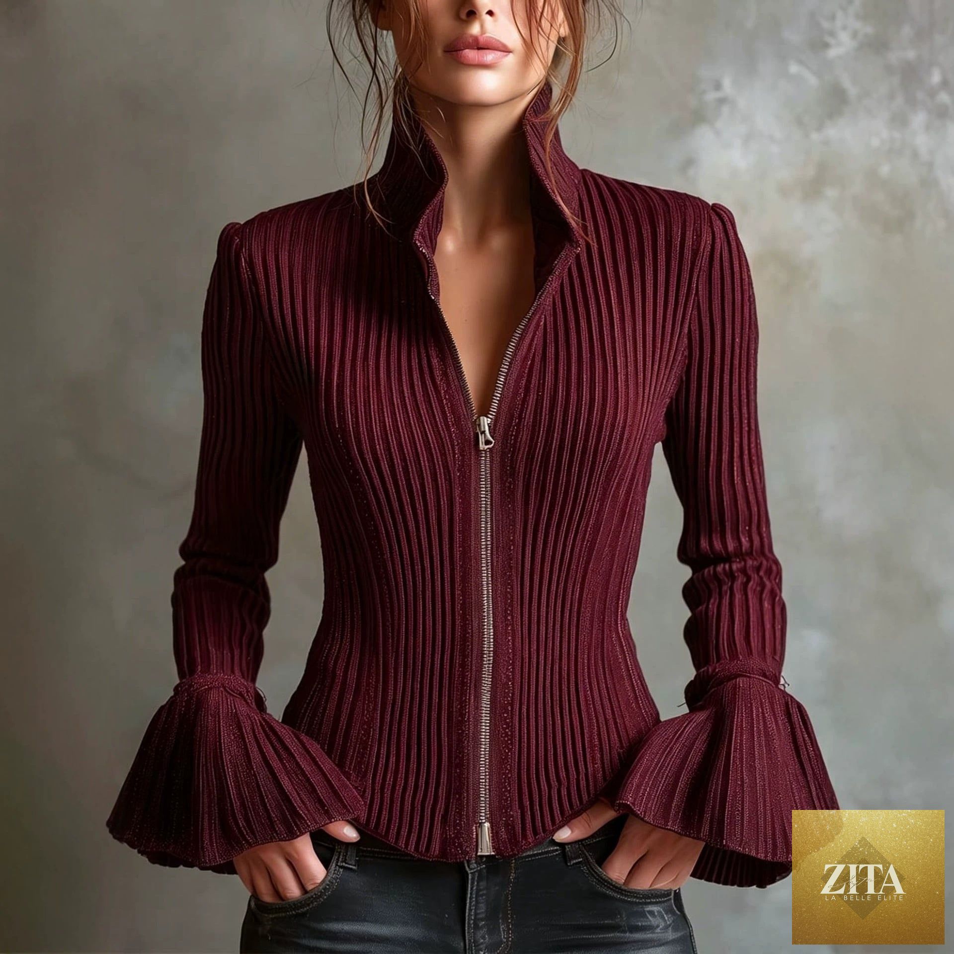 Women's slim-fit rib-knit zip-up top with flared cuffs by FitiqueFit, shown in a close-up of the stylish design and fabric texture.