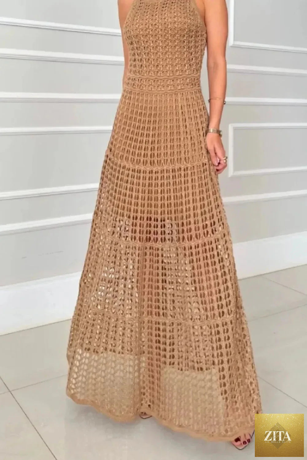 Hollowed-out sleeveless maxi dress by Shopiebay, flowing design with cut-out details, perfect for summer or casual wear.