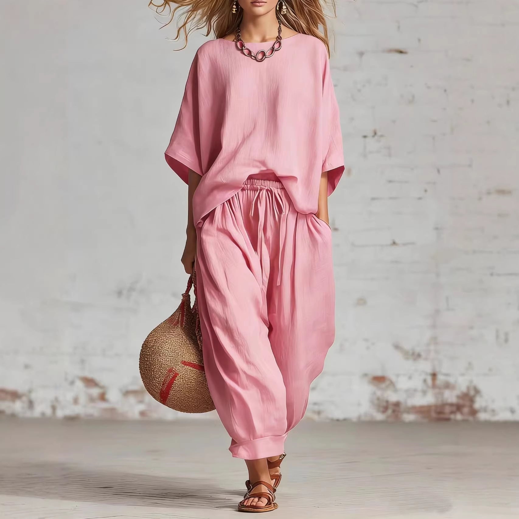 Women's solid color casual set from FitiqueFit featuring a loose T-shirt and ankle pants, laid flat on a white background.