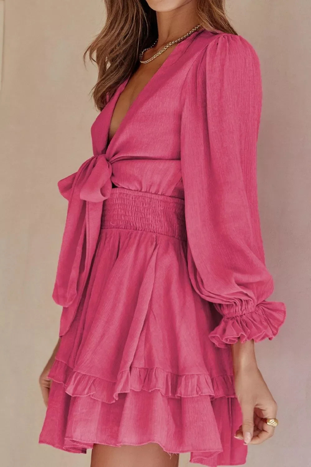 Elegant tie-front ruffle mini dress with smocked waist by Shopiebay, featuring floral patterns and lightweight fabric.
