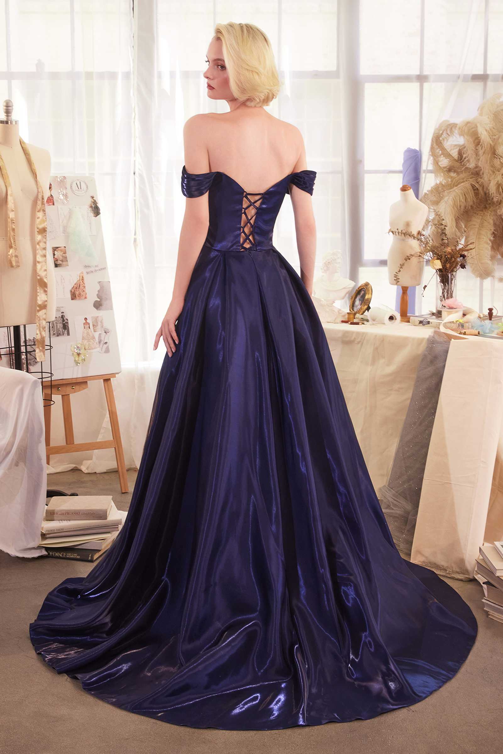 Navy Andrea & Leo A1424 off-the-shoulder organza ball gown dress with full skirt and elegant design, displayed from the back.