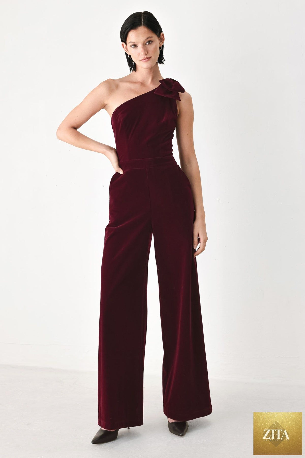 BERRY AFTER DARK VELVET BOW ONE-SHOULDER JUMPSUIT