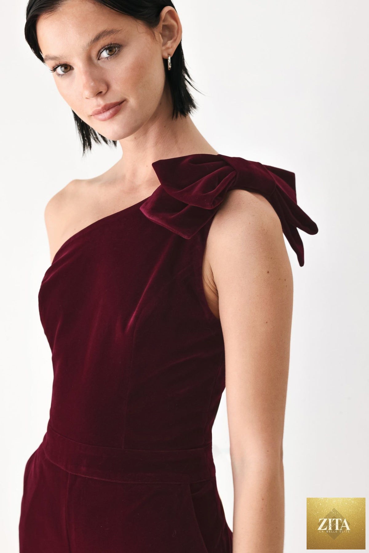 BERRY AFTER DARK VELVET BOW ONE-SHOULDER JUMPSUIT