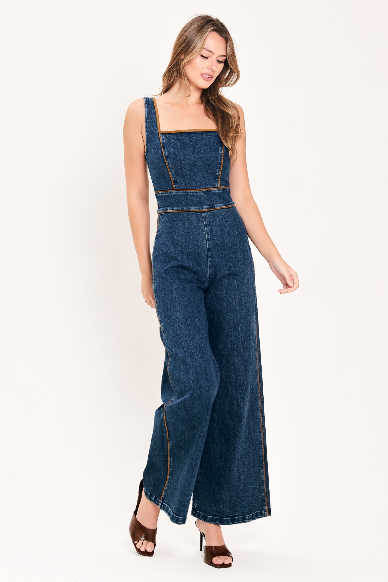 Flying Tomato Western Star Daydream denim jumpsuit in medium indigo with short sleeves and front pockets.