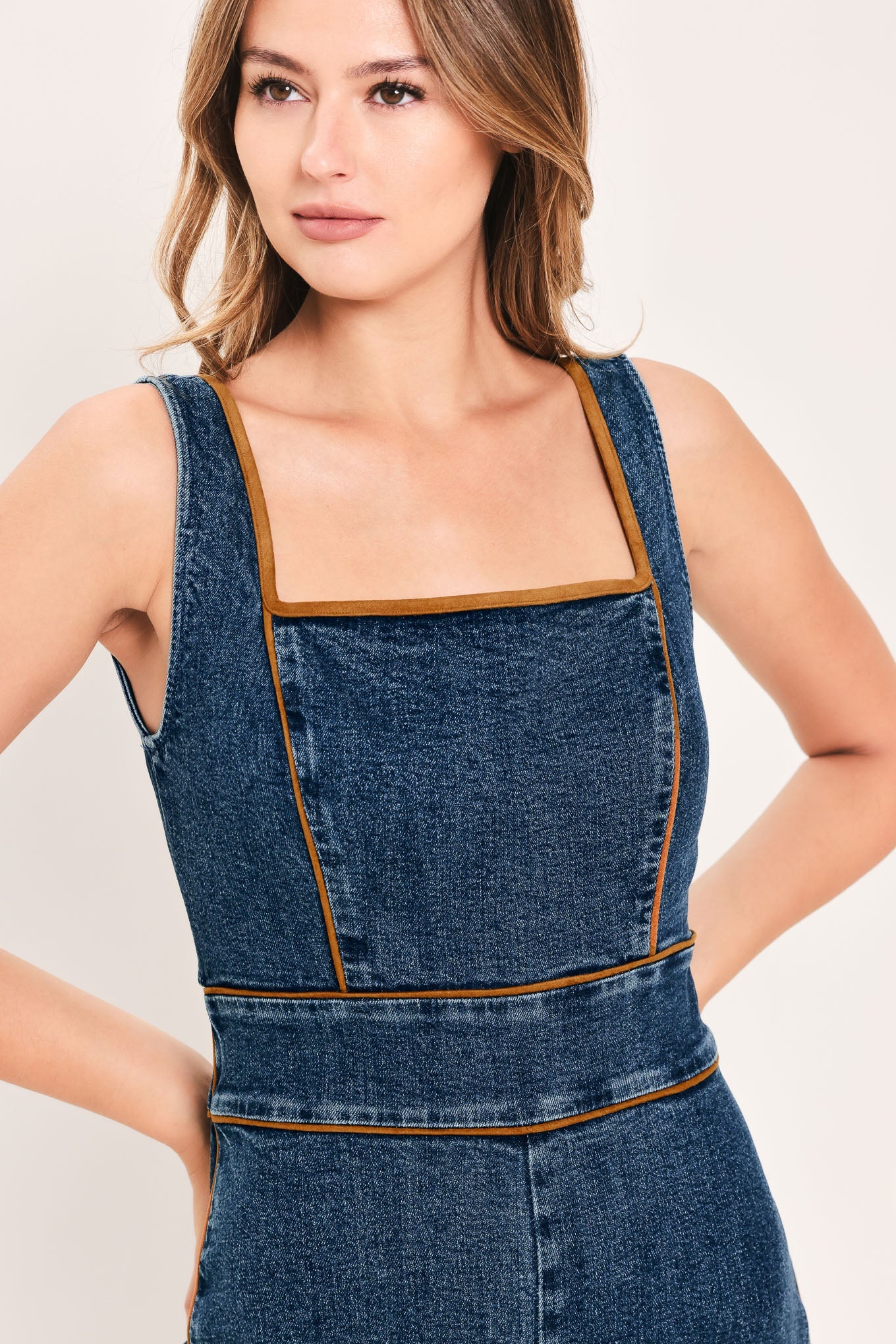 Flying Tomato Western Star Daydream denim jumpsuit in medium indigo with front pockets and adjustable straps.