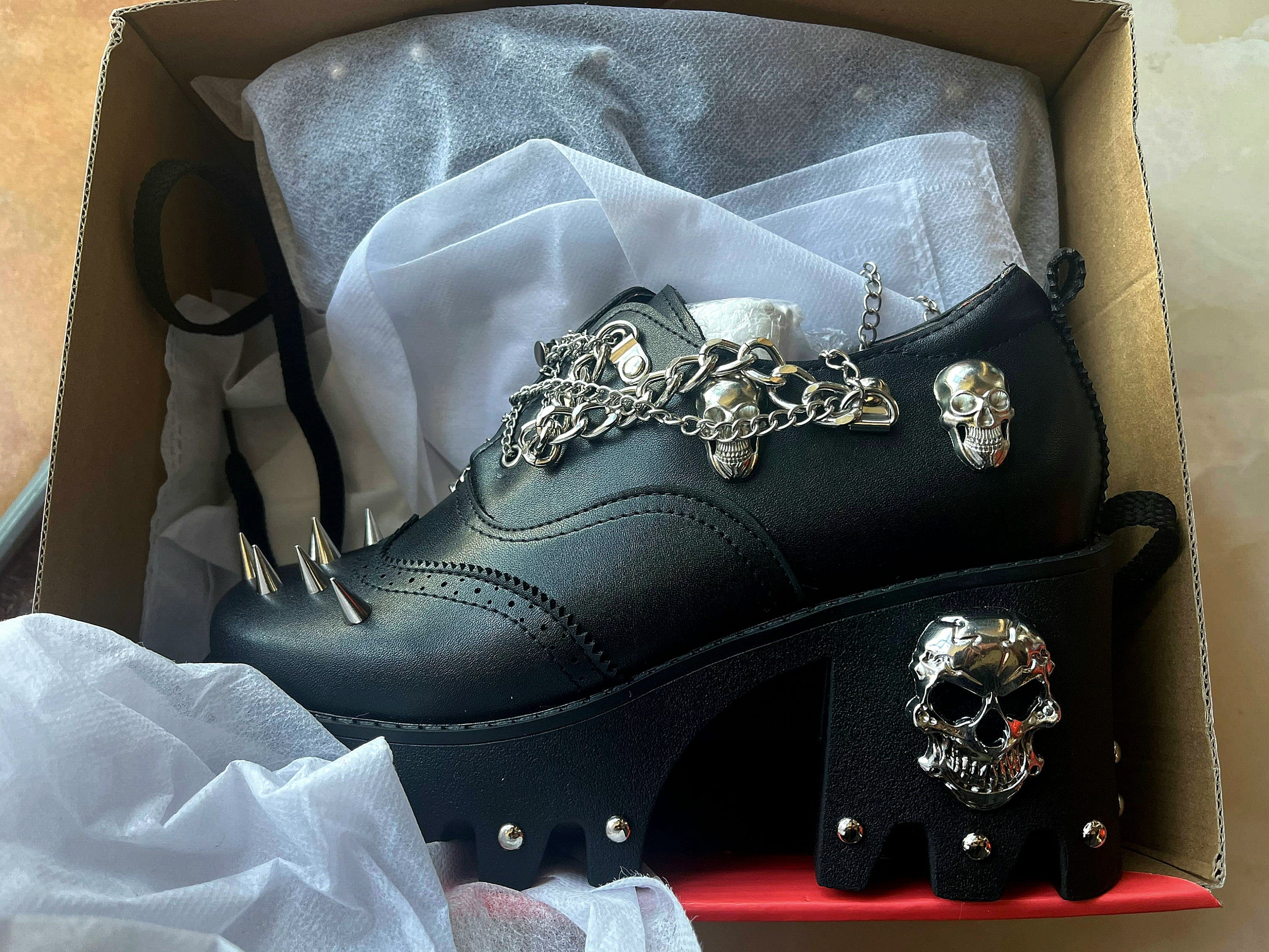 Women's skull shoes with spikes by donjohnbyvictoriacharles, featuring dark design and edgy style, shown on a white background.