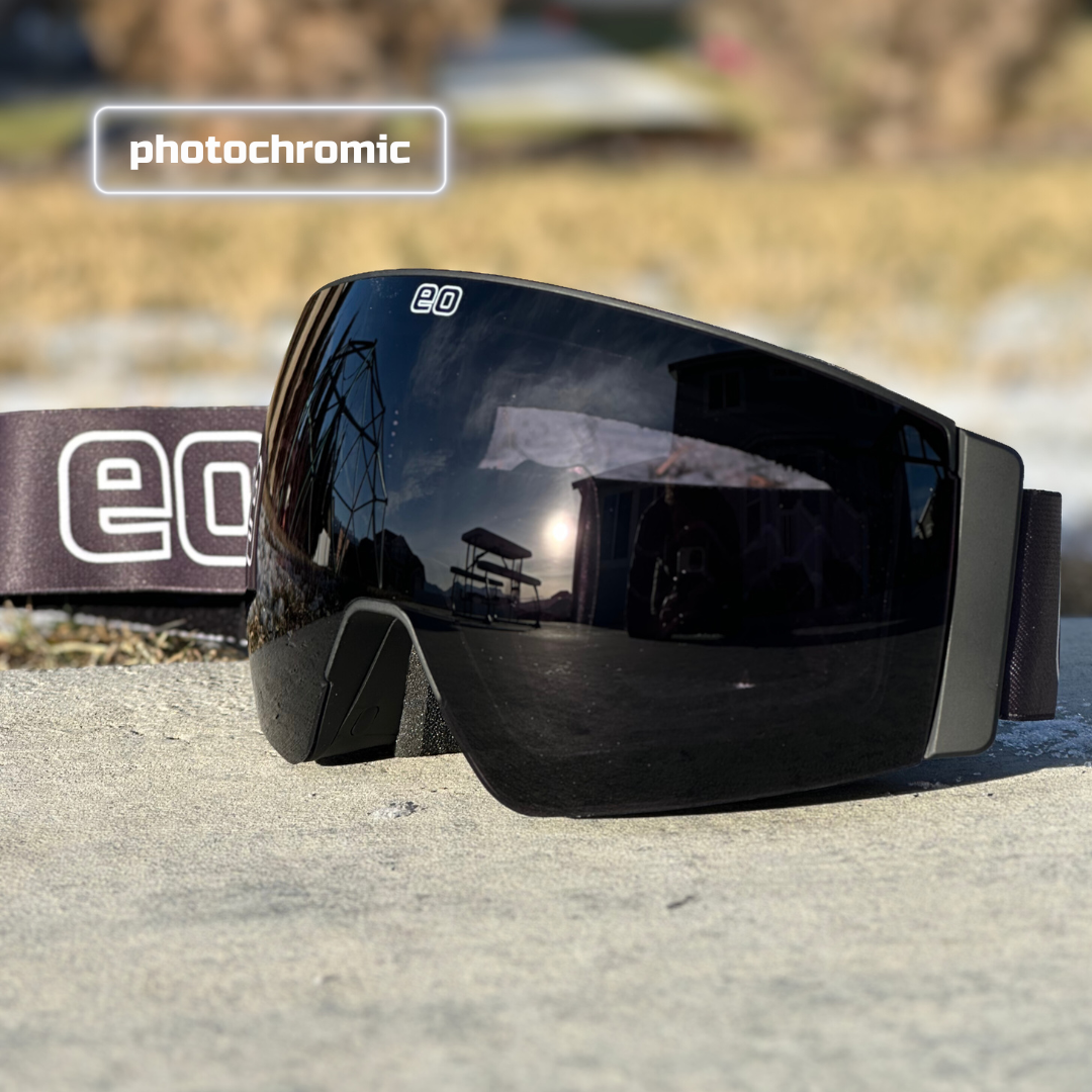 Eastern Outer Mach Schnell Mag photochromic ski and snowboard goggles in black with dark lenses, angled view.