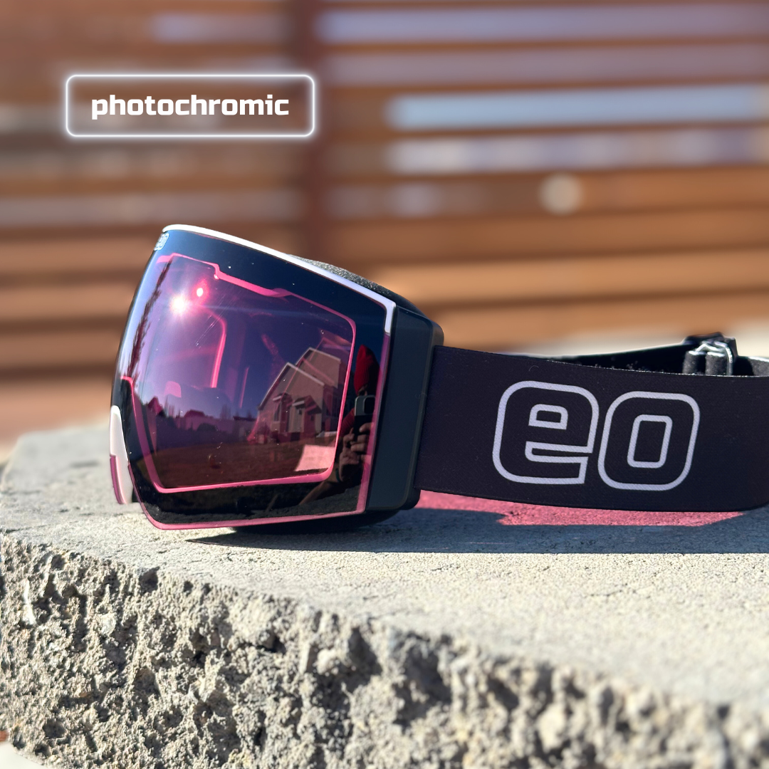 Eastern Outer Mach Schnell Mag photochromic ski and snowboard goggles with black frame and rose-tinted lenses, angled view.
