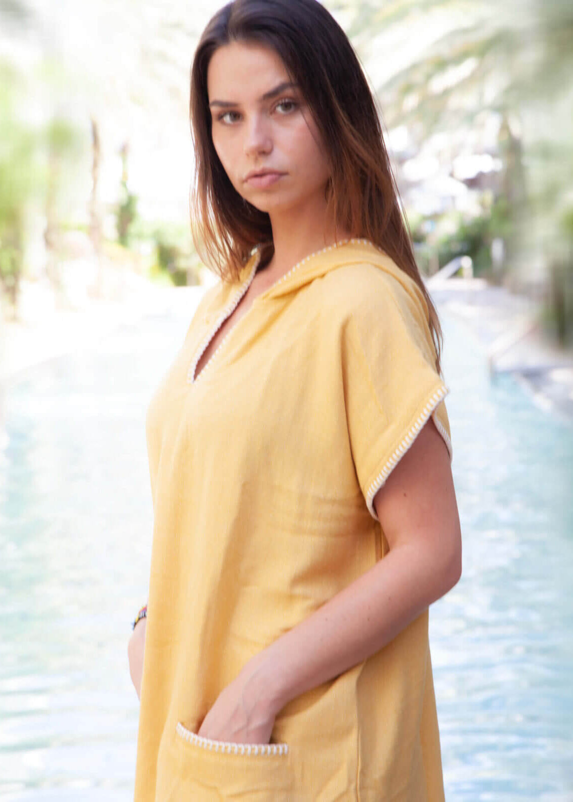 Yellow buldano beach cover-up poncho with hood, lightweight and comfortable for seaside wear.