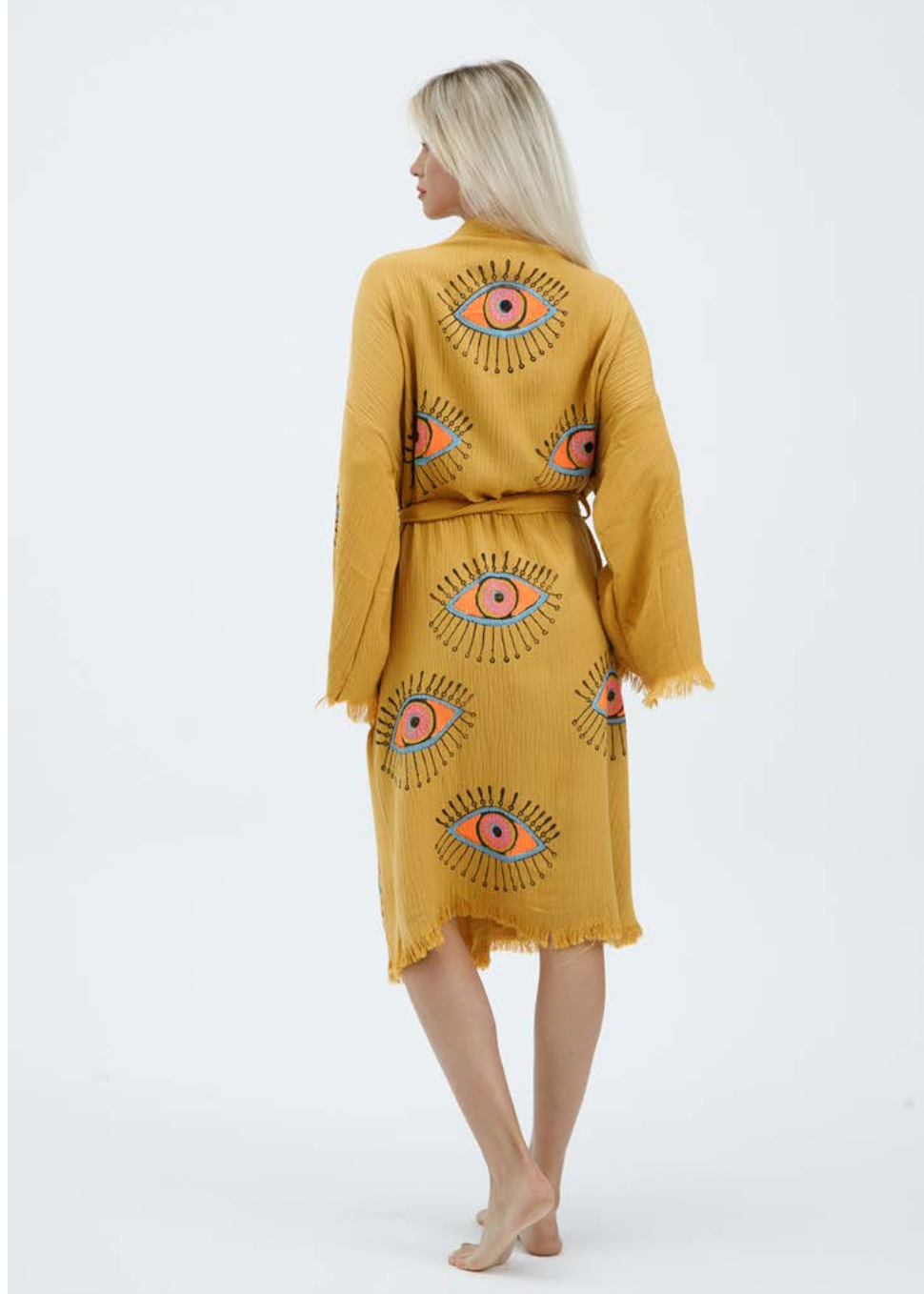 Yellow evil eye hand-printed kimono by Buldano, featuring natural fabric and intricate design, worn as stylish traditional clothing.