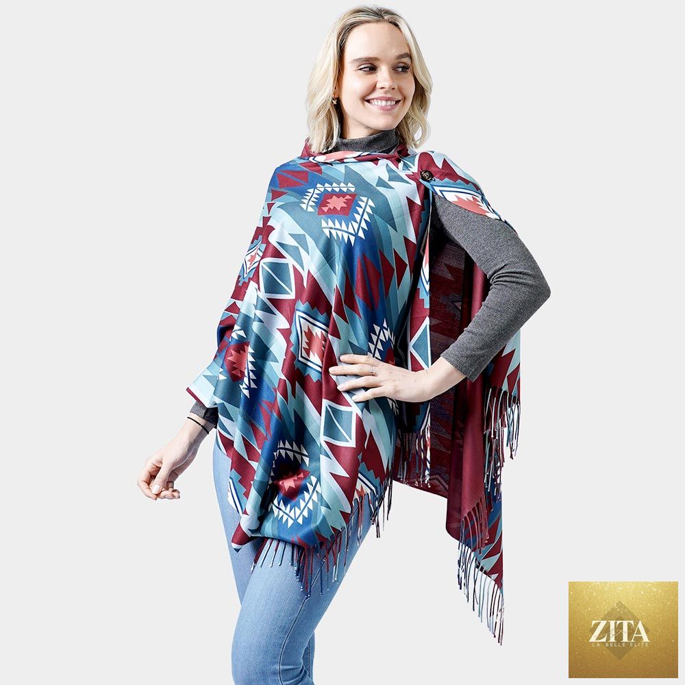 Madeline Love double-sided Western shawl or poncho with fringed edges in blue, showcasing intricate patterns and cozy fabric.