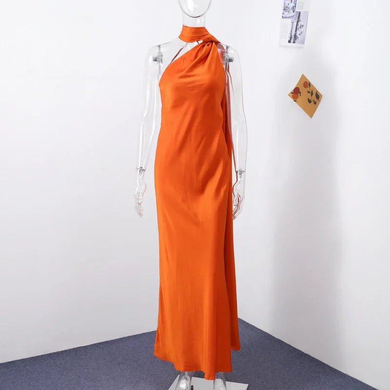 Backless lace-up maxi dress by Femstylo featuring sleeveless design and elegant ribbon details for evening occasions.