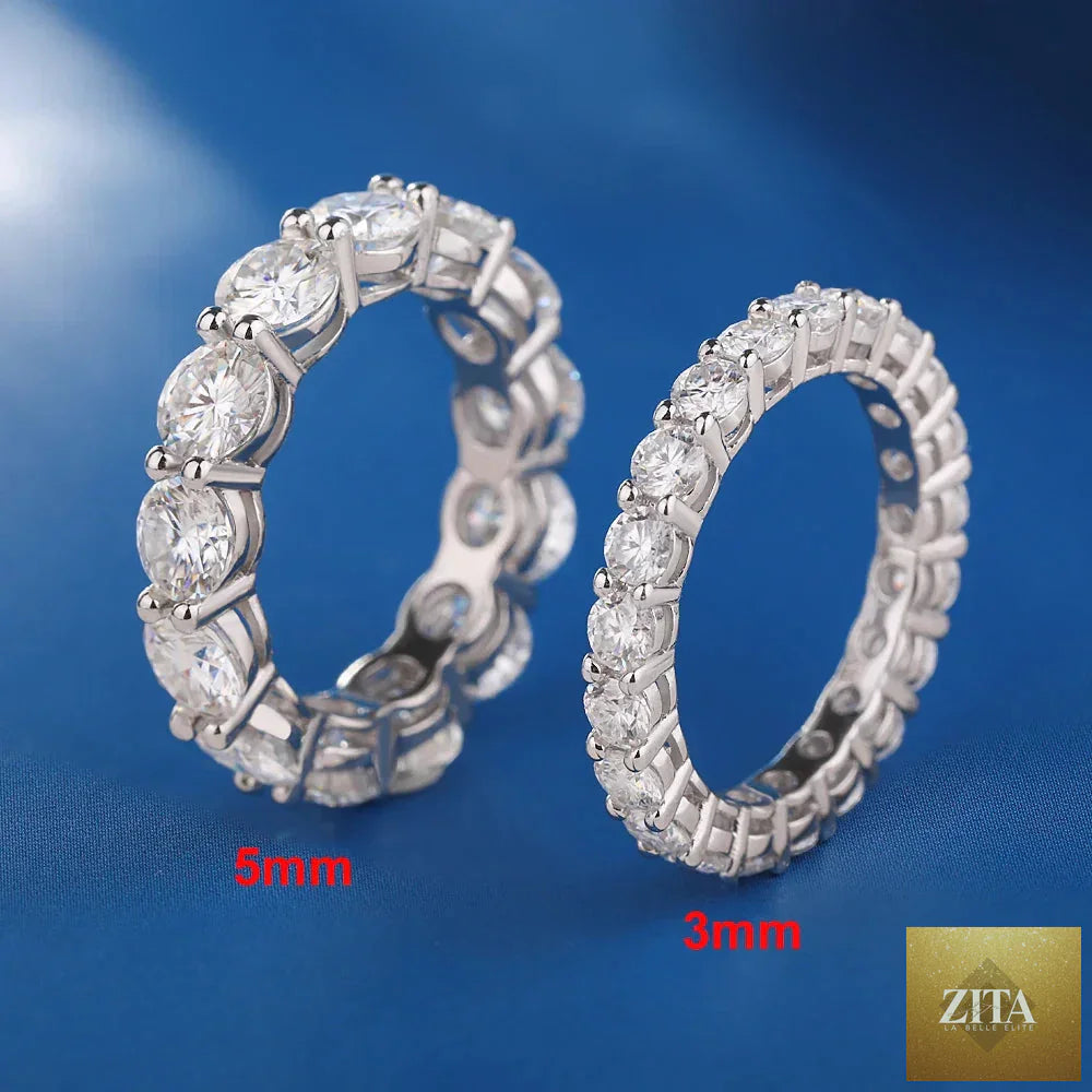Sterling silver wedding band with 5mm D color moissanite row, featuring sparkling stones and a polished finish, crafted by FLIPSTYLEZLLC.
