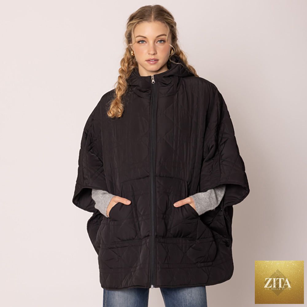 Black Madeline Love puffer cape poncho with quilted design and cozy style, shown on model with open front.