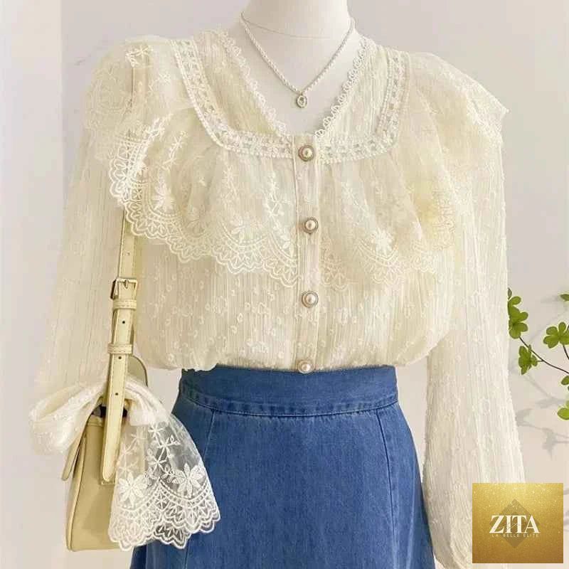 Elegant white blouse with ruffled accents and long sleeves, suitable for office wear, by Corporación Turística.
