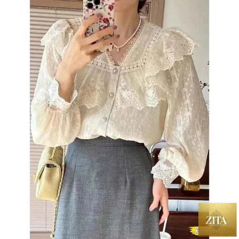 Elegant white blouse with ruffled details and long sleeves, ideal for office wear, by Corporación Turística.