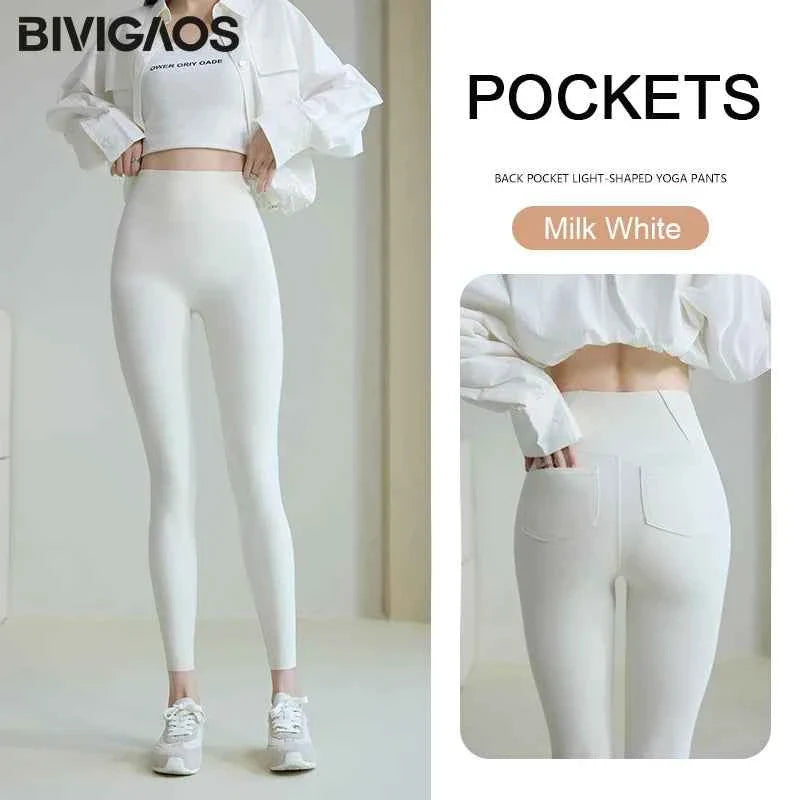 White THRIXINE BIVIGAOS women's sharkskin leggings with smooth, shiny fabric and fitted design, shown on a model.