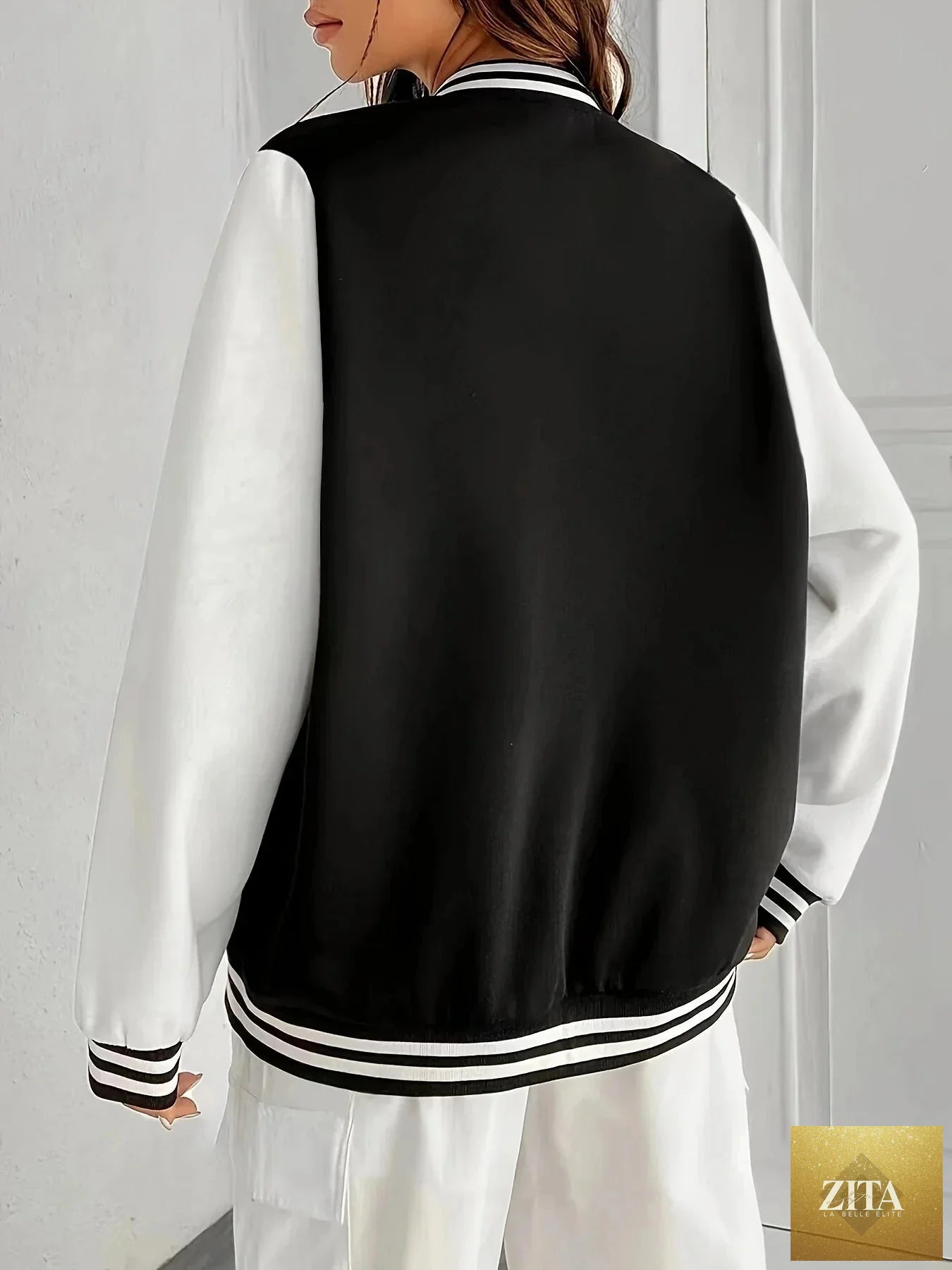 Women’s oversized solid color baseball jacket by FitiqueFit, shown in a casual style with front pockets and ribbed cuffs.