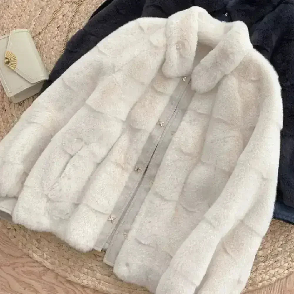 White faux fur jacket with vegan leather trimmed cuffs, long sleeves, and a cozy collar, available in sizes S to XXL.