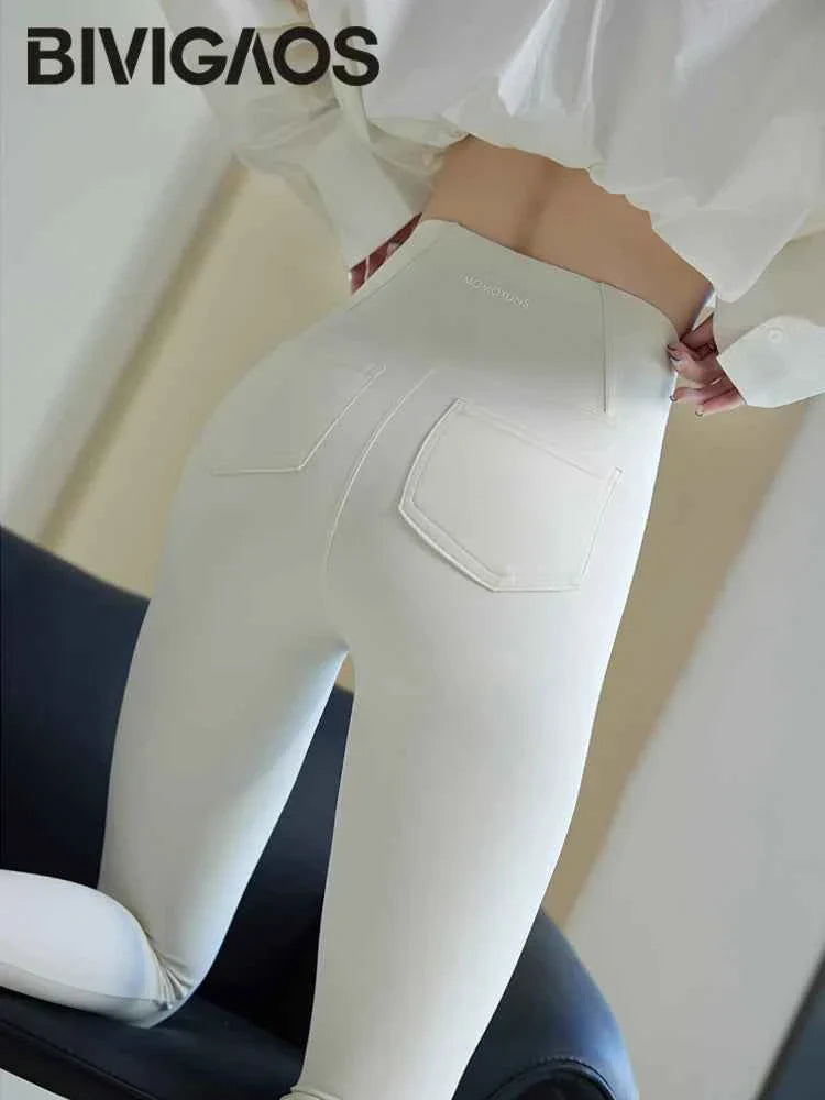 White BIVIGAOS women's sharkskin leggings by THRIXINE featuring sleek, textured fabric and a comfortable fit.