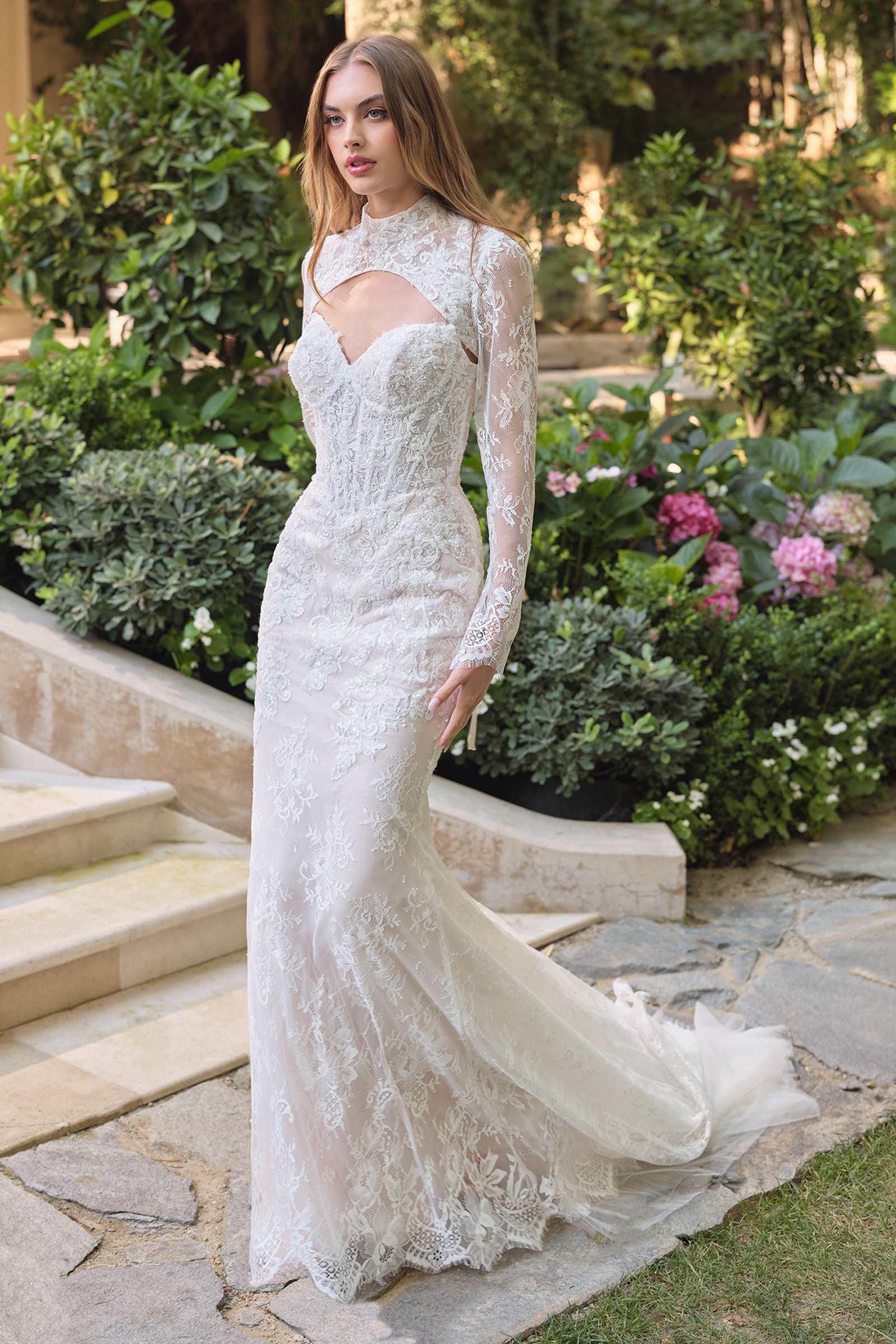 Elegant white fit and flare wedding dress with lace overlay and matching bolero jacket, designed by Andrea & Leo.
