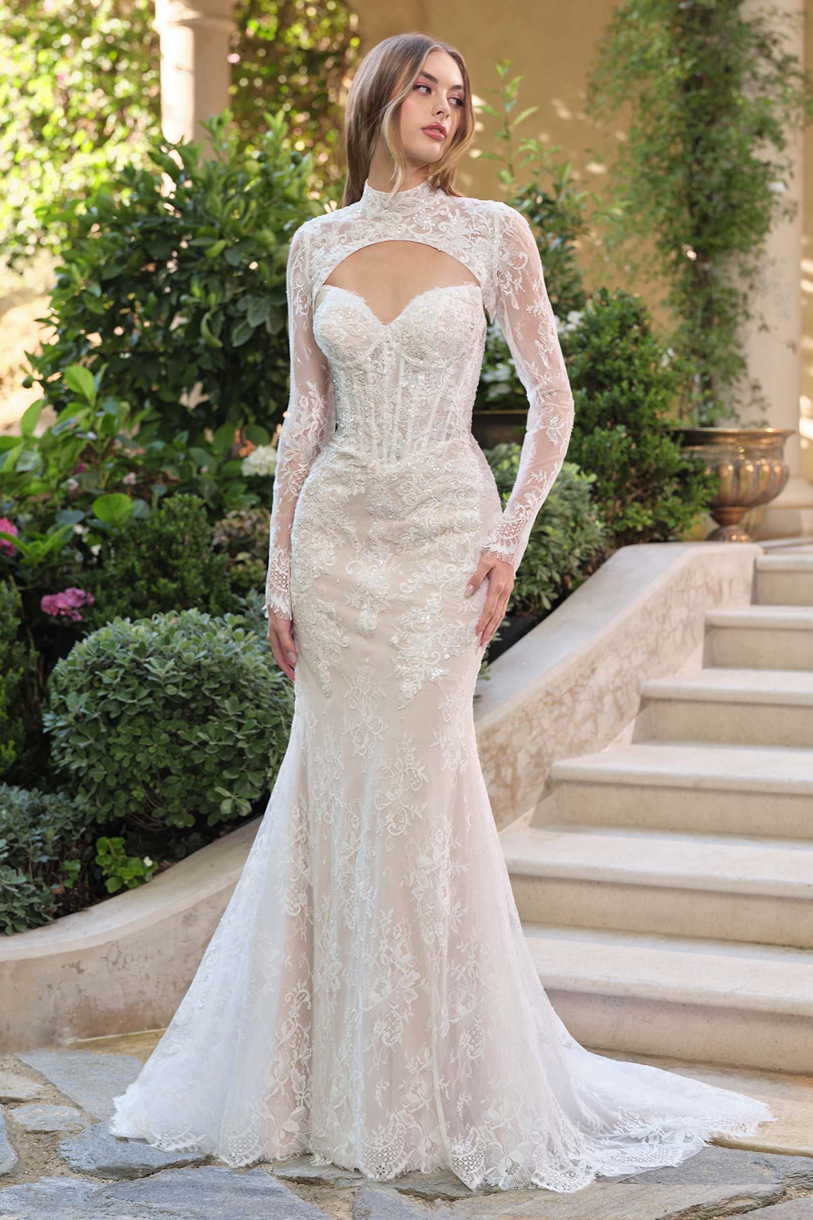 White fit and flare lace overlay wedding dress with nude accents and matching bolero jacket, shown from the front.