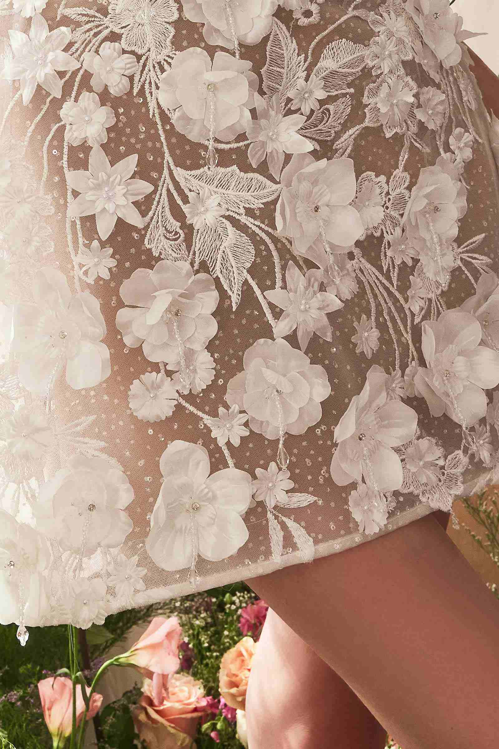 White and nude strapless bridal midi dress with floral and lace details, featuring a dimensional design from Andrea & Leo WL085.