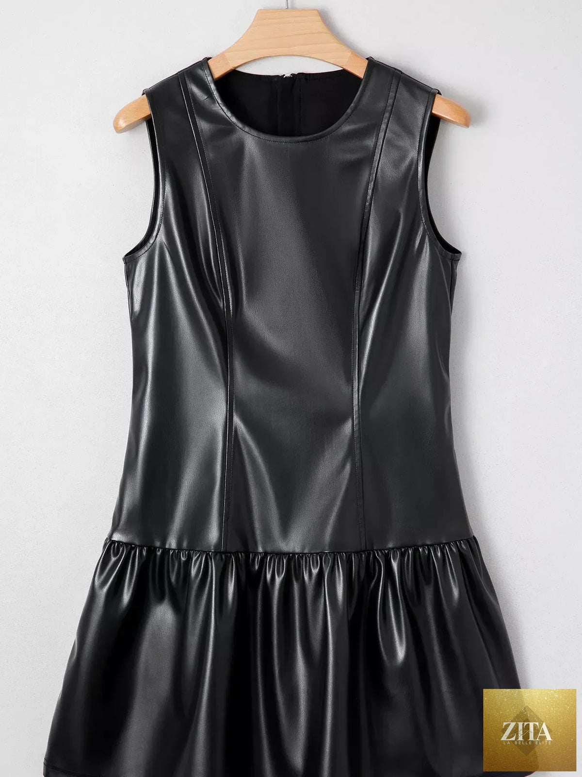 Faux leather sleeveless mini dress with ruffle hem, stylish and fitted, from Shopiebay, shown in black on a model.