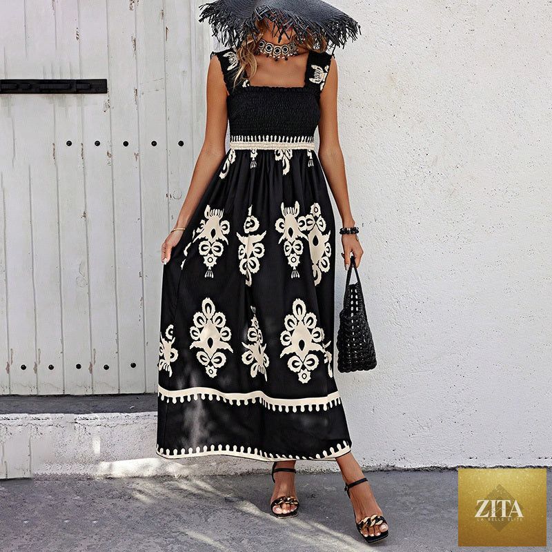Women's printed maxi dress by MERIDGE featuring wide straps, smocked bodice, and tassel waist detail.
