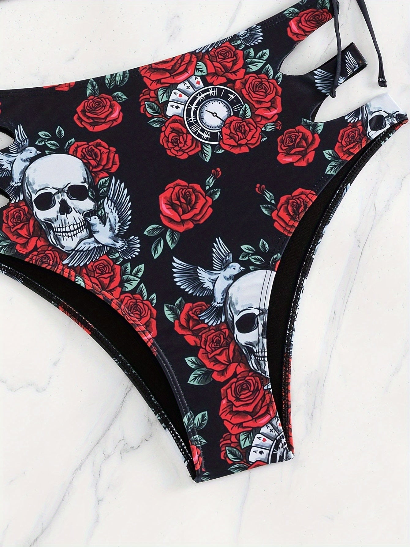 Stevvex bikini set with skull print, lace-up floral design, hollow-out style, crew neck, high stretch fabric for beach and summer.