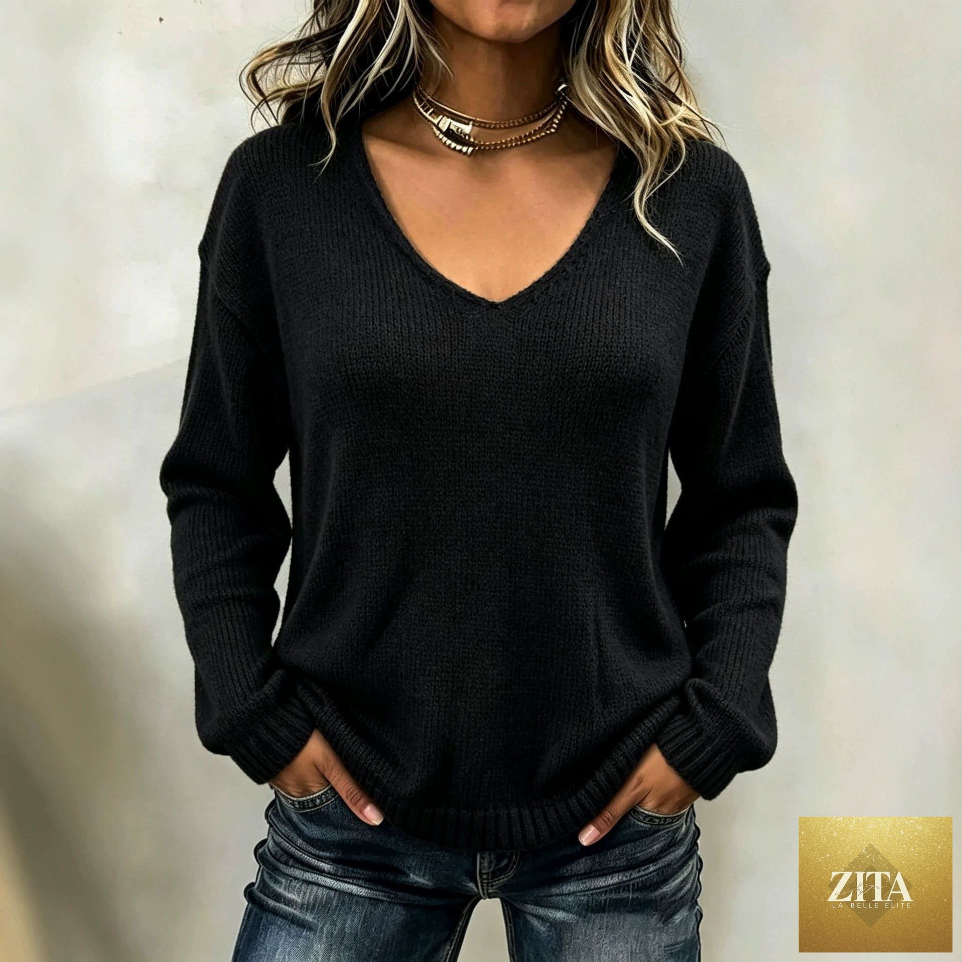Women's relaxed FitiqueFit V-neck drop-shoulder sweater with a cozy knit design and casual fit, perfect for layered styling.
