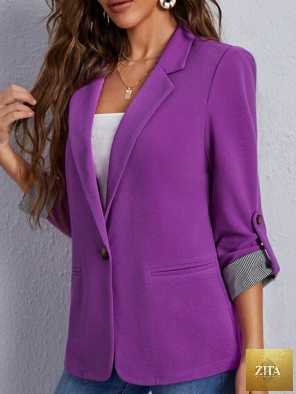 SITRA lapel collar blazer with roll-tab sleeves, tailored fit, and classic design, shown in a stylish, professional look.