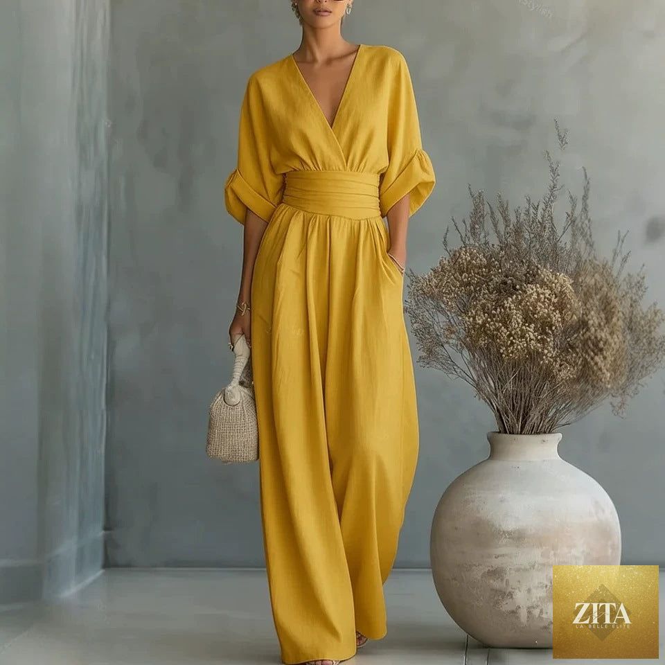 Women's MERIDGE V-neck wide-leg jumpsuit with high waist and pleated details, displayed on a hanger showcasing its elegant style.