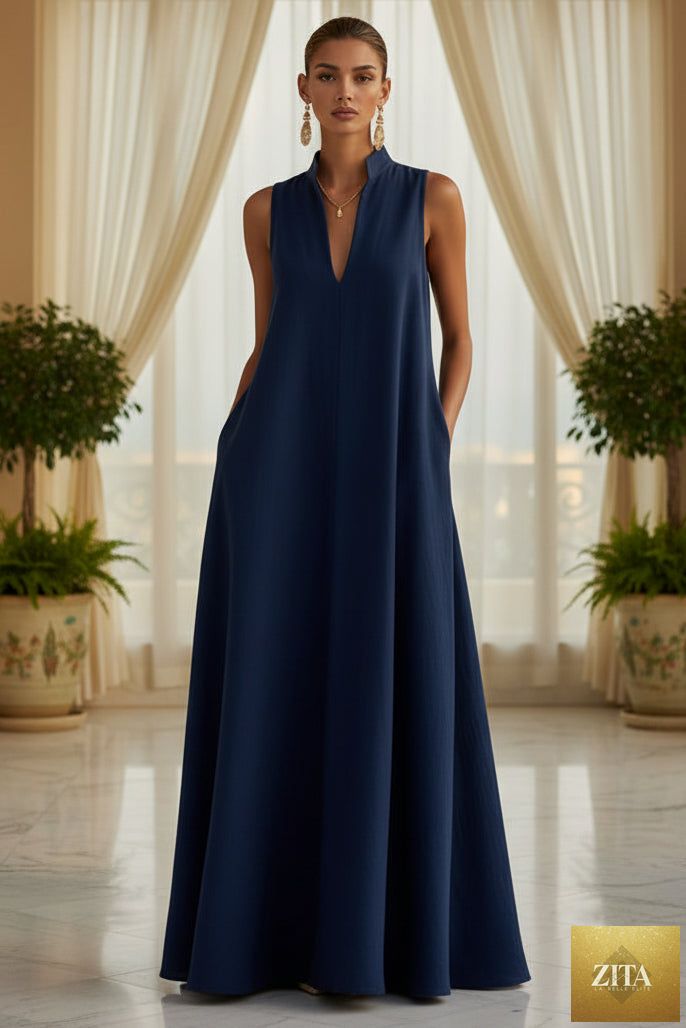 Women's sleeveless stand-collar maxi dress by MERIDGE, featuring a flowing fabric and elegant design, shown on a model.