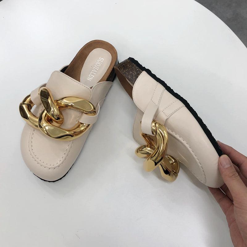 Stevvex women's slip-on slippers with metal chain design, closed round toe, low heels, casual flat slides in gold chain detail.