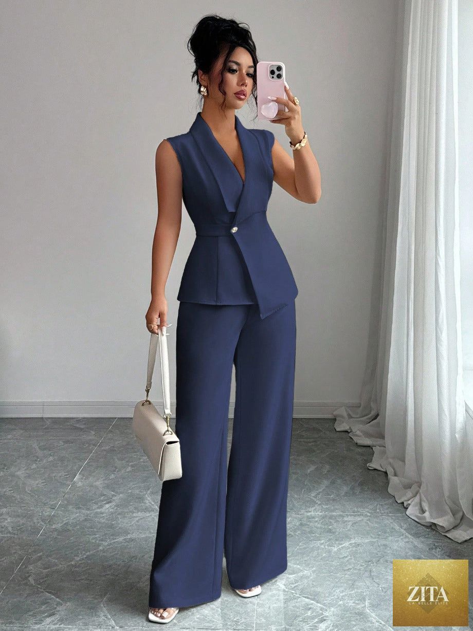 Women's MERIDGE peplum sleeveless blazer and wide-leg pants two-piece set, shown on a model. Stylish, tailored fashion ensemble.