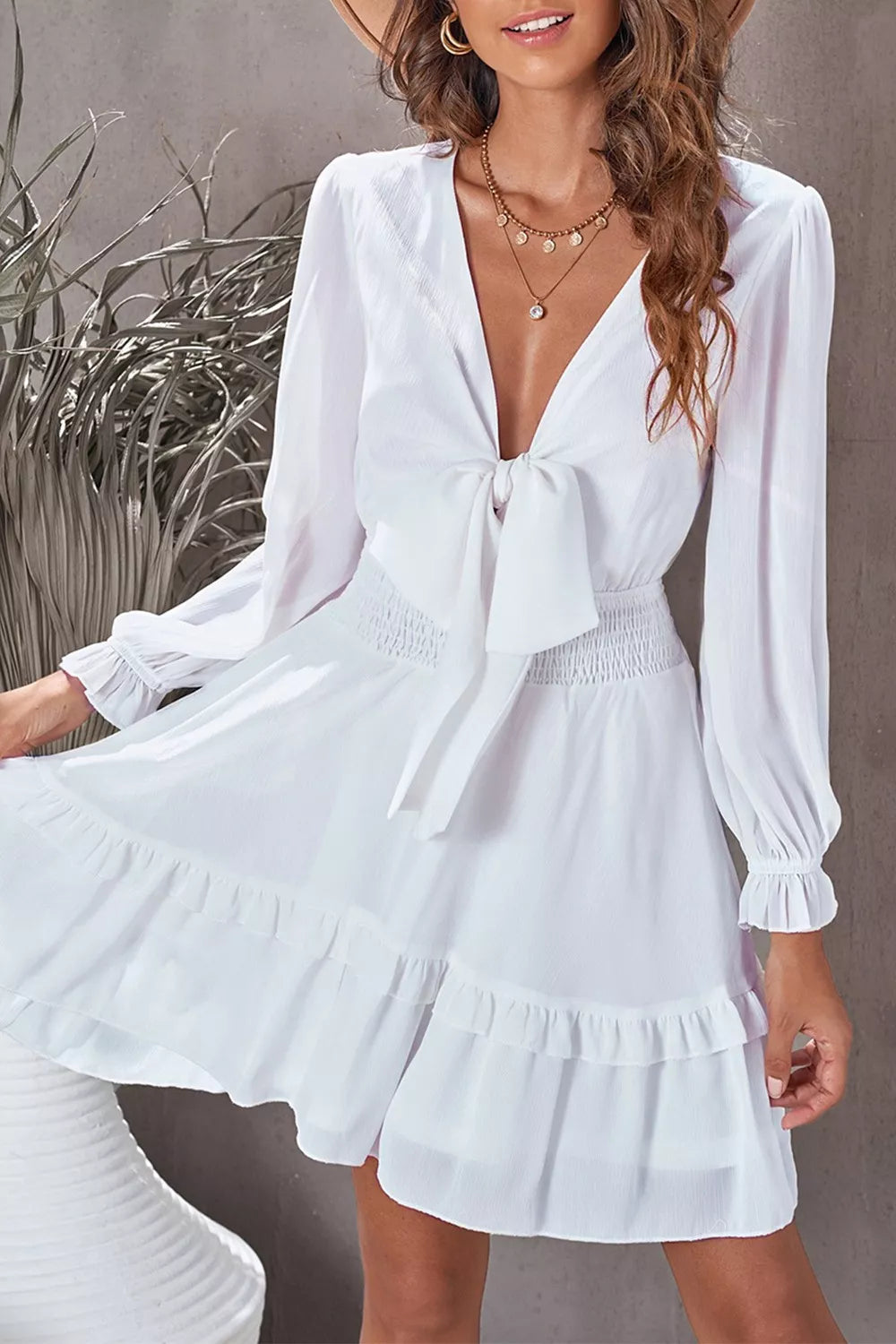 Elegant tie-front ruffle mini dress with smocked waist by Shopiebay, featuring a stylish neckline and feminine ruffle details.