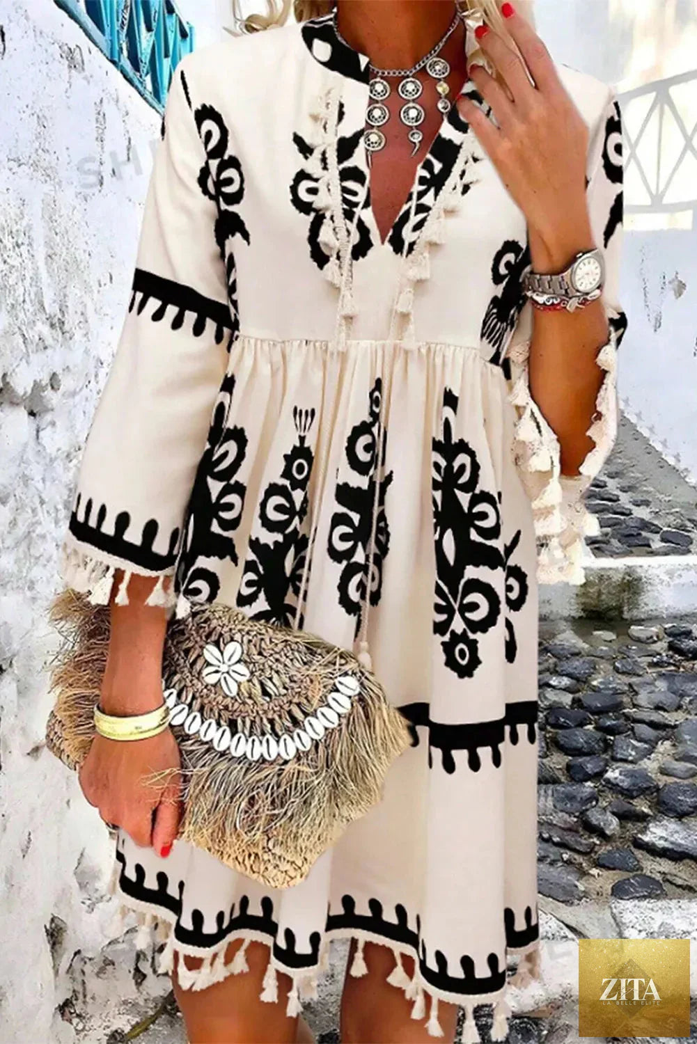 Tassel printed three-quarter sleeve mini dress by Shopiebay featuring colorful patterns and a stylish, casual design.