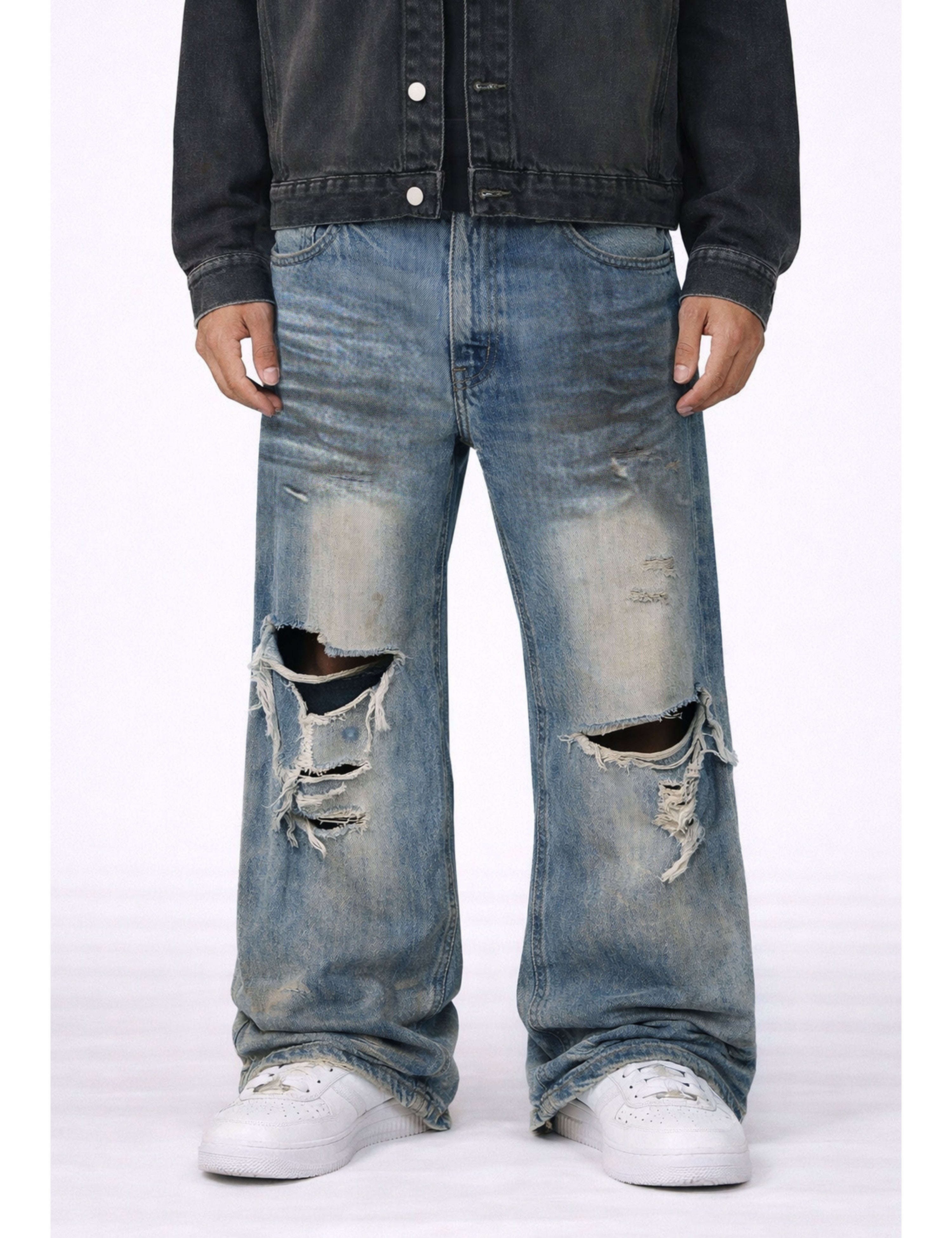 Light-wash UNDEVELOPED WIDEBOY Destroyed Denim jeans with distressed details and frayed hems, displayed on a hanger.