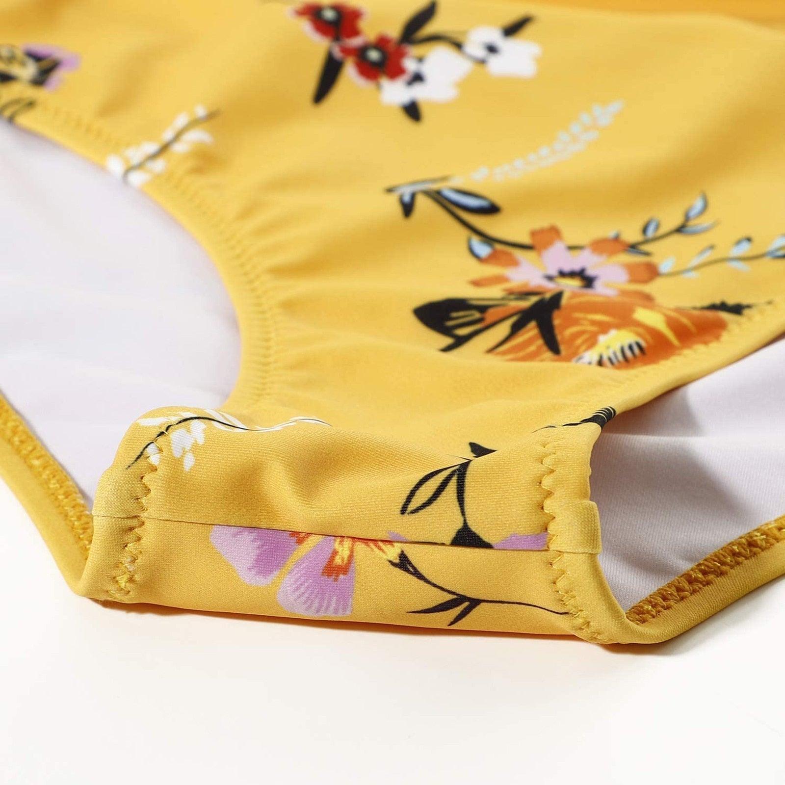 Stevvex modern floral two-piece bikini set with high waist, crisscross design, flower print, and solid color swim shorts for women.